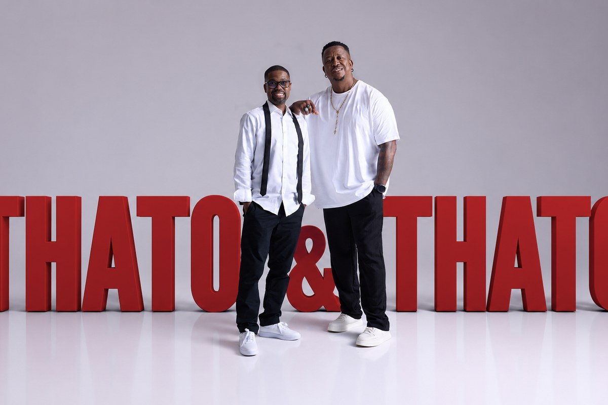 Two male radio presenters posing together with large red 'THATO & THATO' text, promotional photo for breakfast show